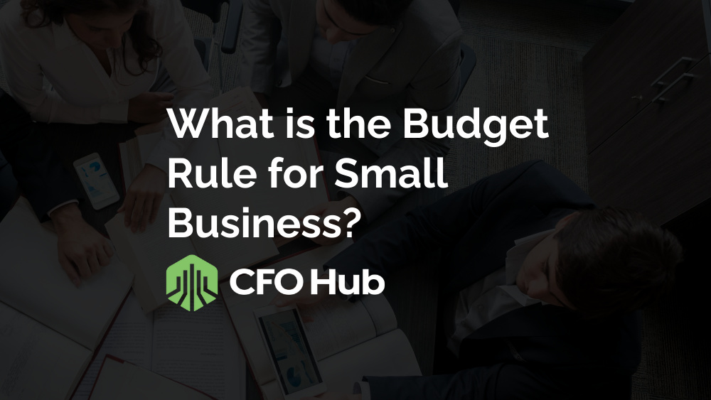 A top-down view of three people sitting at a table cluttered with documents and a laptop. The text overlay reads “What is the Budget Rule for Small Business in Financial Planning?” with the CRI CFO Hub logo below it. The background is darkened to highlight the text. A top-down view of three people sitting at a table cluttered with documents and a laptop. The text overlay reads "What is the Budget Rule for Small Business in Financial Planning?" with the CRI CFO Hub logo below it. The background is darkened to highlight the text.